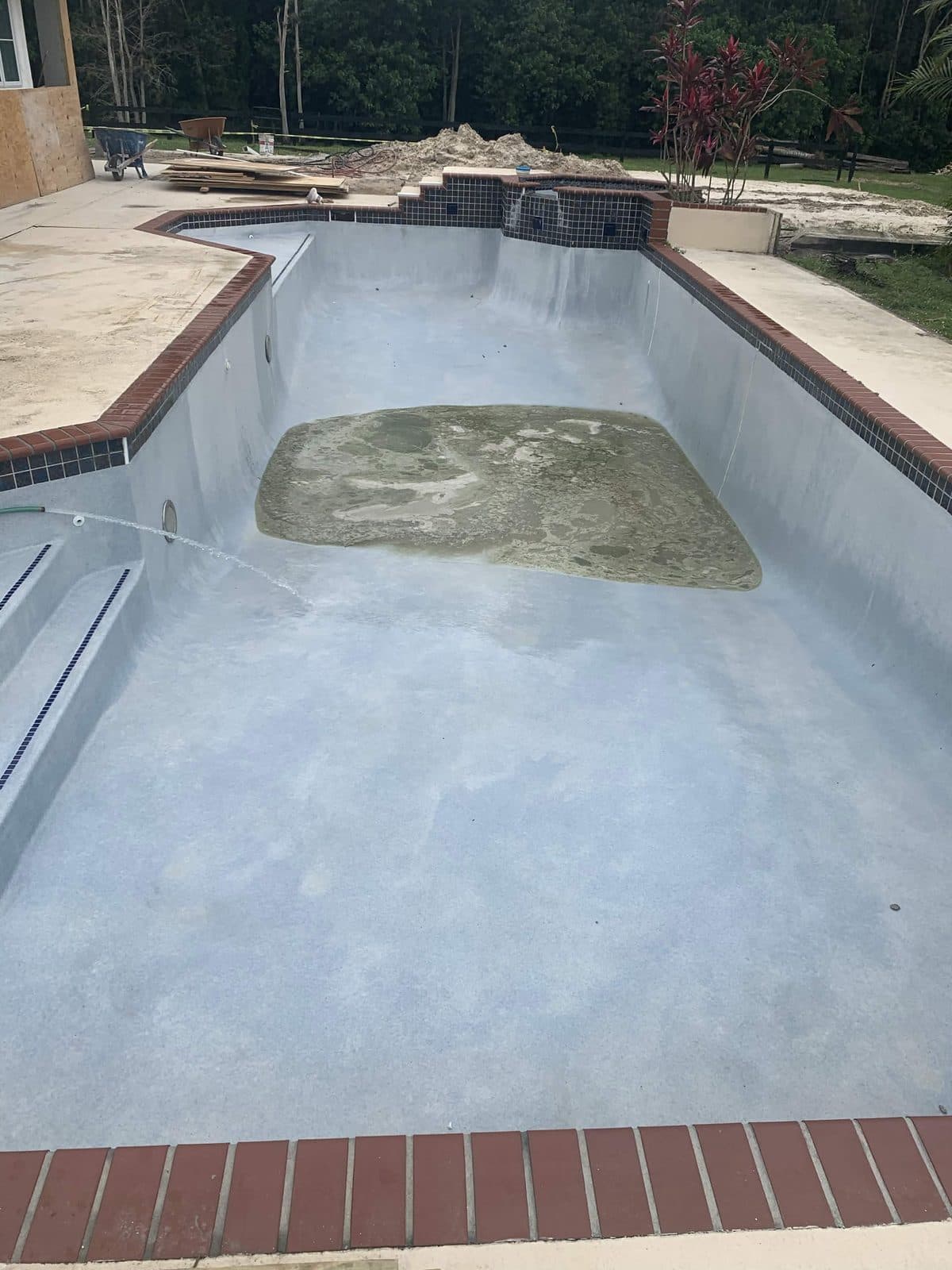 The same pool fully acid washed down to fresh even plaster and ready to refill in Lake Worth FL