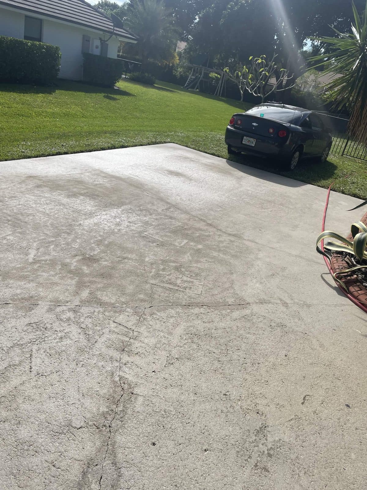 The same concrete driveway bright and even after pressure washing in Wellington FL