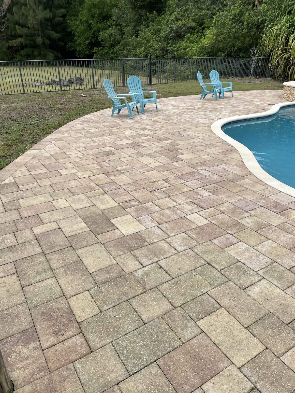 The same poolside pavers washed back to warm sand tones in Royal Palm Beach FL