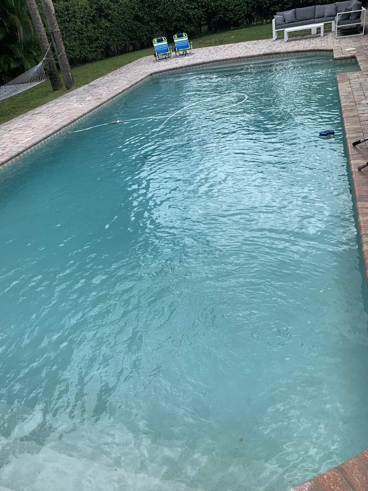 The same rectangular pool cleared and vacuumed after a service visit in Loxahatchee FL